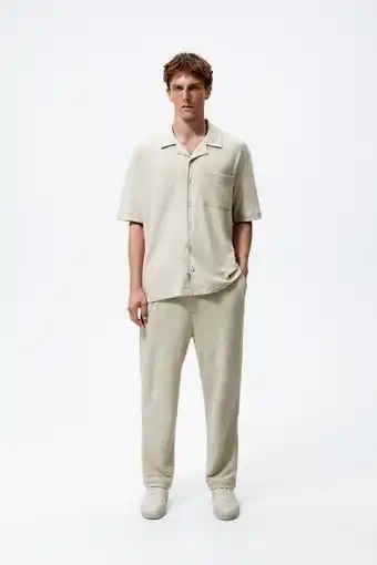 ZARA Creased-effect trousers offer