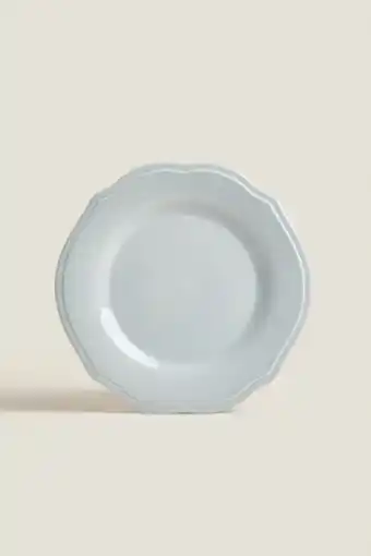Blue dinner plate with raised-design edge