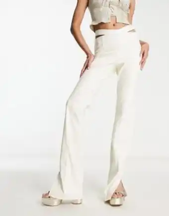The couture club high waisted cut out trousers in cream